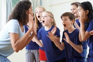 School age children acting with teacher