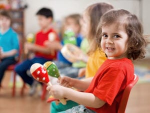 Preschool girl with music morracas
