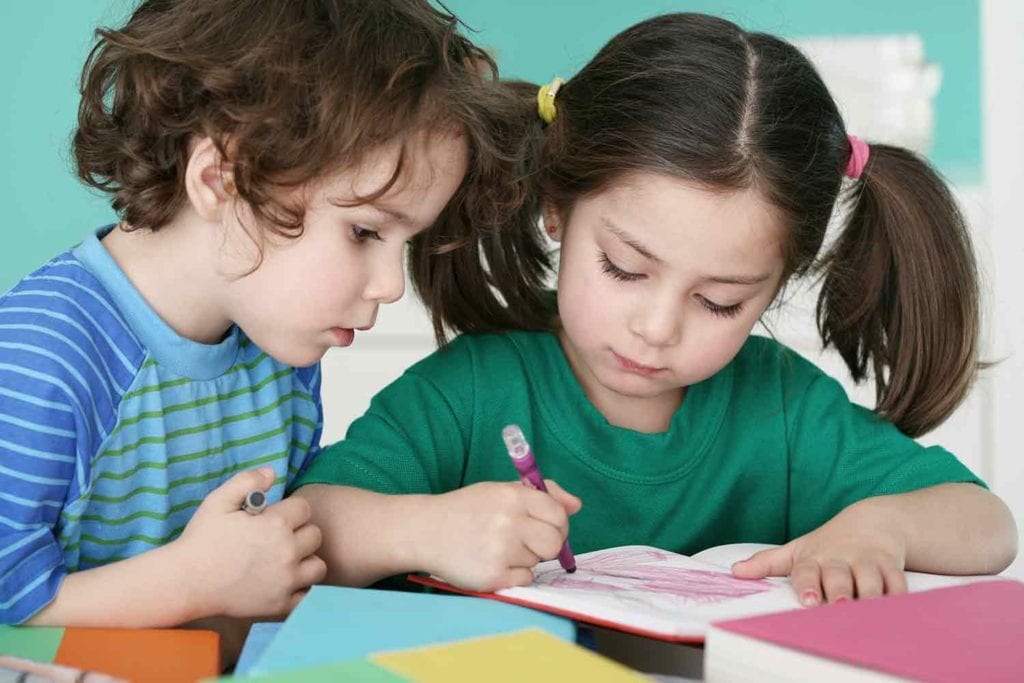 preschool children writing at day care