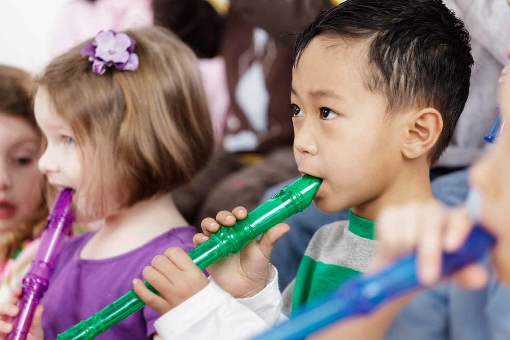 Preschool students playing the flute