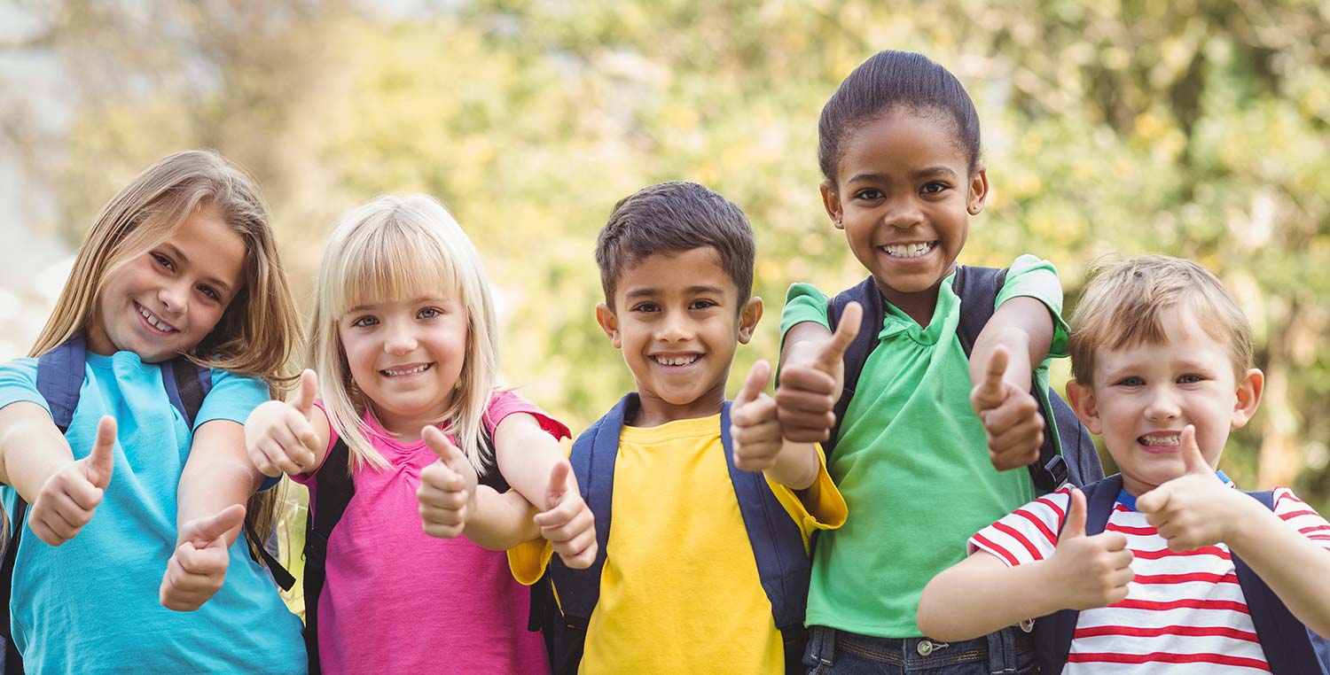 Preschool group of kids smiling with thumbs up